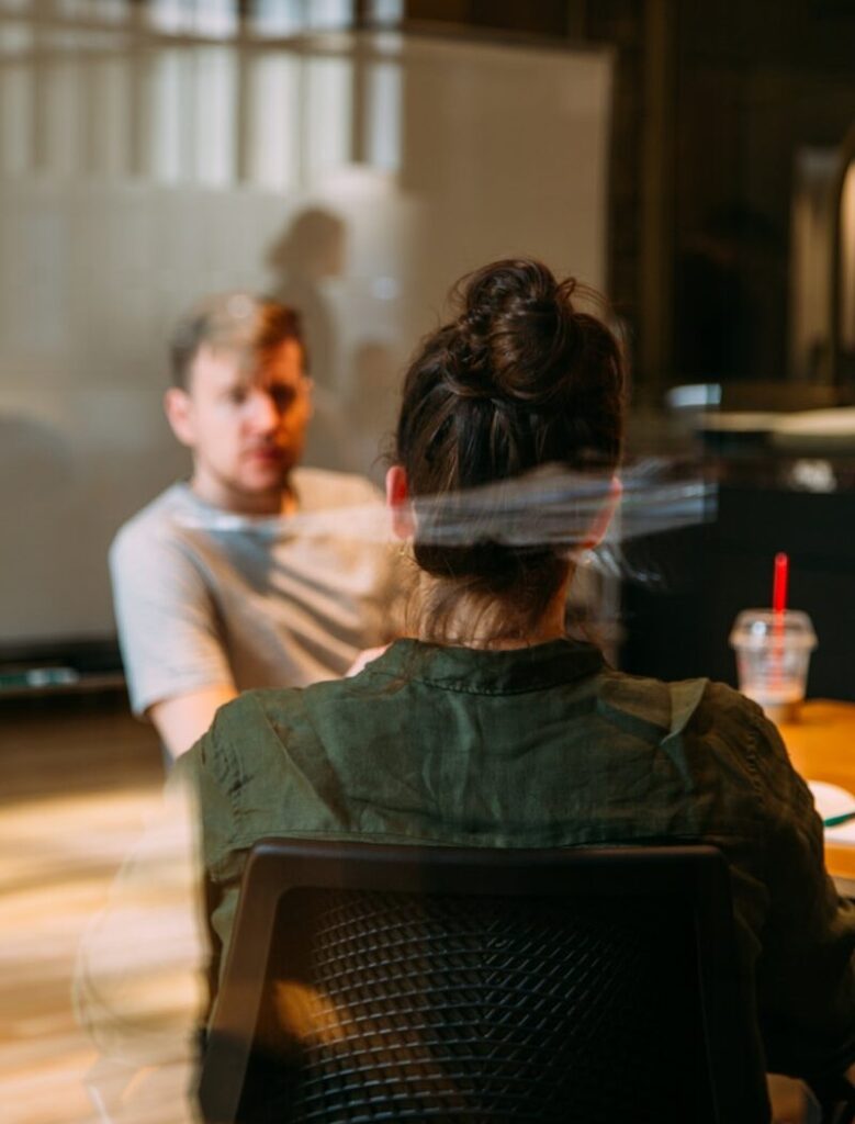 person sitting in a chair in front of a man